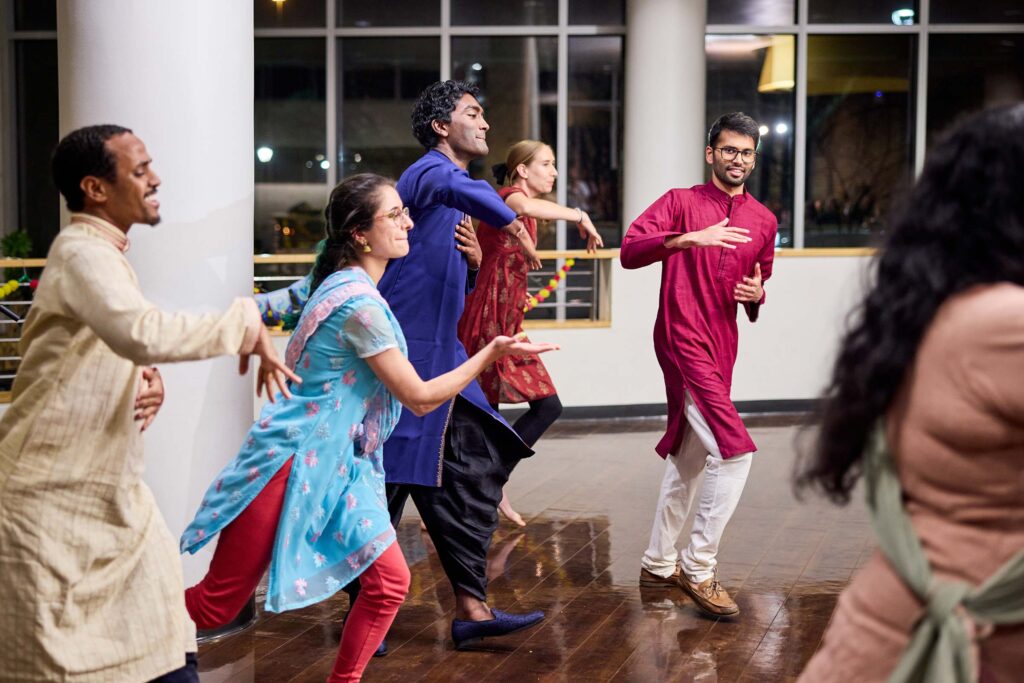 MSTP student Abraham Ogbaslase, left, MD students Avan Antia, Pramodh Ganapathy, Anna Dowling, and MSTP student Kalyan Tripathy (in red) perform. Students gathered at Shell Cafe to celebrate Diwali